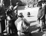 An American photographer interact with local people in a village in Yunnan during WWII.