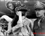 Ann Sheridan (white knitted hat) signs an autograph, with Ruth Dennis in the center foreground. Along with Mary Langdon and Ben Blue they were at Yangkai Air Base, China, on a USO tour in the CBI. In this photo they had just finished helping the 22nd Bomb Squadron dedicated their aircraft 'Sheridan Express' . John A. Johns (22nd B.S., deceased) painted the nose art just before Miss Sheridan arrived at Yangkai. After the war John became rather famous for his caricature art.