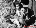 Local farmer in China, in Yunnan province, near Yangkai, with a small dog. During WWII.