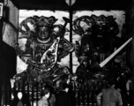 People look at the protective deities at the entrance to a Buddhist temple in China during WWII.