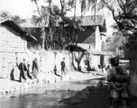 Local people near Yangkai, Yunnan province, China, walk a village pathway. During WWII.