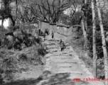 Kids run on a village path at a village near Yangkai, Yunnan province, China, during WWII.