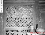 Traditional woodwork on door panels in China. During WWII.
