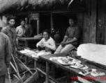 A pork seller in a village market in Yunnan province, China. During WWII.