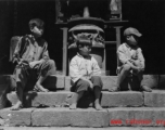 Local people in China: Chinese boys sitting before incense burner. During WWII.