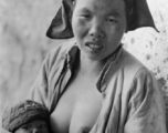 A nursing mother and child in China during WWII.