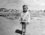 Local people in China, Burma, India: A small child near an American base in China during WWII.