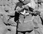 Local kids in Yunnan province, China, during WWII: A girl holds an infant.