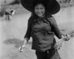 Local people in China: A woman in Yunnan transplants rice seedlings. During WWII.