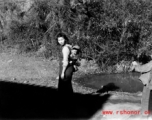 A woman carries a baby on her back in Yunnan province, China, during WWII.