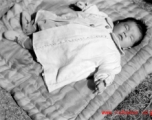 A sleeping baby in China during WWII, in Yunnan province.