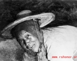 Local people in China: An elderly woman works in the farm fields during WWII.