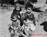 Local people in China during WWII: And older child takes care of younger children. During WWII.