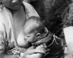 A mother and nursing baby in Yunnan province, China, during WWII.
