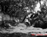 Local people in China: Villagers in Yunnan walk a village path.  From the collection of Eugene T. Wozniak.