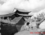 Local people in China: People go through village gate.  From the collection of Eugene T. Wozniak.