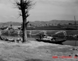 Local people and boat in near Kunming, China, during WWII.