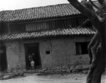 Local people in China--a village home in Yunnan province during WWII.