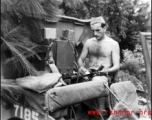 During WWII in China, an American GI operates a portable radio from the back of a vehicle in near Guilin, Guangxi province.