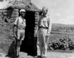 20-28 August 1944  Capt. George D. McGrath, 8266 Fountain Ave., Los Angeles, Calif., Burma Road Engineers, chats with a Chinese guard outside the guard\'s mud and straw shelter, during WWII.  Photo by Pvt. B. E. Einson