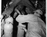 Chinese American Composite Wing (CACW) --"CHINESE AIRMEN GET AMERICAN TRAINING AND EQUIPMENT." The photographer must have laid on his back to get this photo of the Chinese and American crew loading bombs into the rack of a B-25 Mitchell medium bomber.  During WWII in China.  Images courtesy of Tony Strotman.