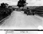 September 29, 1944, Burma Road Engineer's road grader working on the Burma Road and Chinese civilians look on.