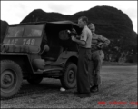 Hal Geer standing near a jeep holding a camera somewhere in Guangxi province, either at Guilin or Liuzhou.