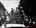 Americans in Jeep shooting movie film in a Chinese town, probably Kunming.