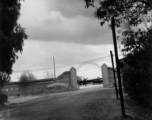 The gate of an airbase in Yunnan province, China, with a C-46 transport showing. During WWII.