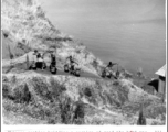 Chinese laborers extract water from the lake near Camp Schiel, Yunnan province, to use to build a road, work done by hand tools and hard labor. During WWII.