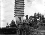 Two American servicemen in SW China area standing in front of pagoda.  Note that the one on the left is a chaplain.