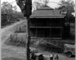 Two linemen putting finish on line from Ledo-Burma Road junction to Allied communications HQ at Lashio, Burma, in 1945, with two technicians up on pole working.