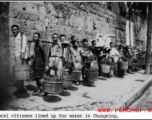 Local citizens lined up with buckets to collect water at Chongqing (Chungking), China, during WWII.