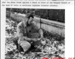 Frank Bond examines discarded "invasion currency" on a Rangoon, Burma, street near Bank of India, where it had been dumped during evacuation. Spring 1945.