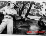 A GI pretends to fight a tiger in a fake forest in a studio in the CBI during WWII.