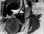 *******A young GI chef, cigarette in mouth, attends to his simple oven full of baked goods. In the CBI during WWII.  Photo from Glenn Hensley.