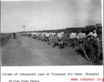 Column of conquered Japanese soldiers at Kiangwan Air Base, Shanghai.  Photo from Milton King.