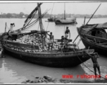 A boat full of coconuts in India or Burma, during WWII.