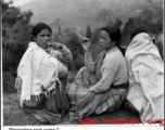 Three ladies smoke on a cold day at the rest camp at Darjeeling. During WWII.