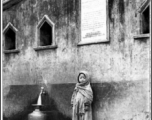 A child at a public well in the Darjeeling, India, area. Readable on the sign above are the words in English "TO THE GLORY OF GOD." During WWII.  Photo from Robert D. Lichty.