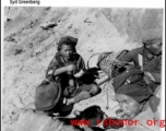 Workers take a break to eat, possibly resting from road building in SW China or Burma. During WWII.