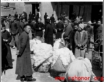 Cotton buyers and sellers in Xi'an (Hsian) in 1943 negotiate their trades.