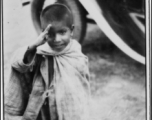 A kid salutes the photographer in the CBI during WWII.