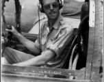 A GI sits in the cockpit of an airplane in the CBI during WWII. Kesterson.