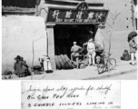 Chinese soldiers looking on at tire shop in Kunming, China, October 1945.