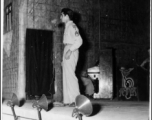 A GI stands at the microphone during entertainment of the CBI, as the Jive-o-Lieps are ready at their instruments. During WWII.