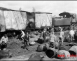 Chinese workers sorting through the aftermath of Japanese bombing raid on railway with load of fuel barrels. Liuzhou, China, September 1944.  From the collection of Frank Bates.