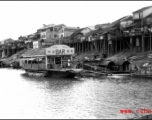 The bar barge and stilted houses at Liuzhou. Looking toward the other side of Liuzhou from the boat bridge, Sept. 1944.   From the collection of Frank Bates.