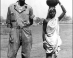 A GI and a woman carrying a pot on here head. India 1942 or 1943.