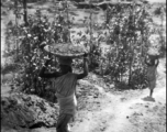 Indian woman "Hauling dirt for 72's Revetment, Chaukulia, India 1943."